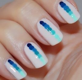 Stylish Gradient Dot Nail Art in Varied Blue and Teal Shades on White Background.