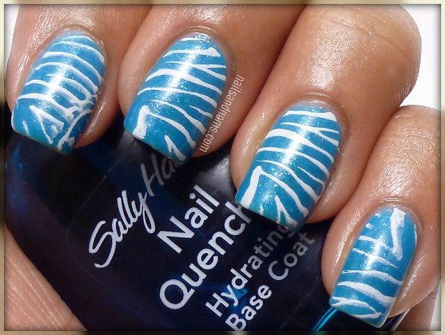 Bold Blue Nails with Striking White Abstract Design for a Vibrant Summer Look.