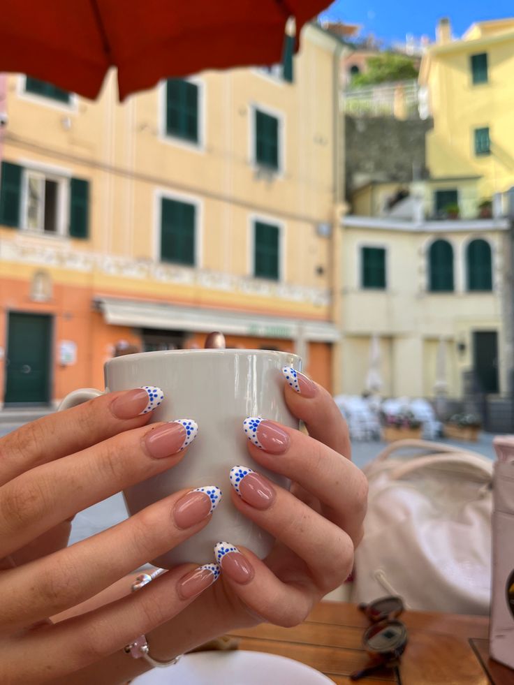 Chic Soft Nude Nails with White Tips and Blue Polka Dots: Versatile Elegance for Any Occasion