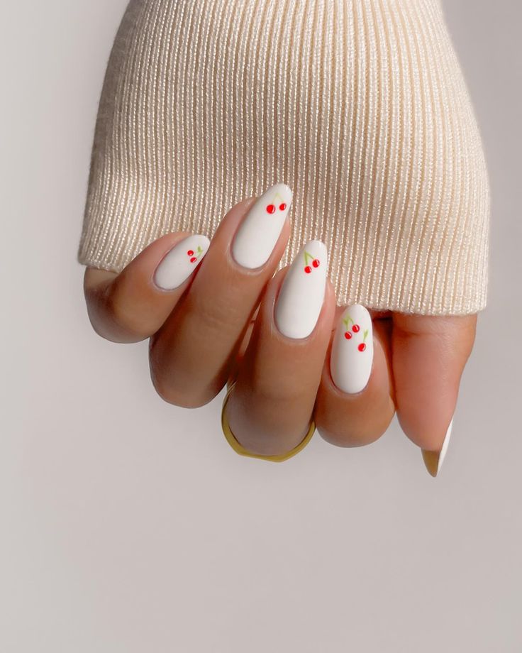 Chic Oval Nails: Sleek White Base with Playful Red Accents.