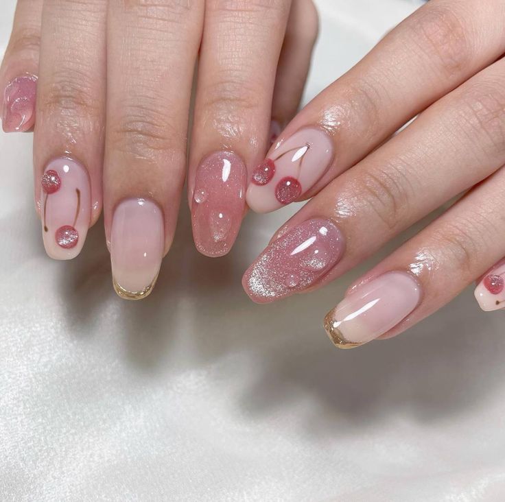 Elegant Nail Design with Soft Pink, Glitter Accents, and Golden Tips.