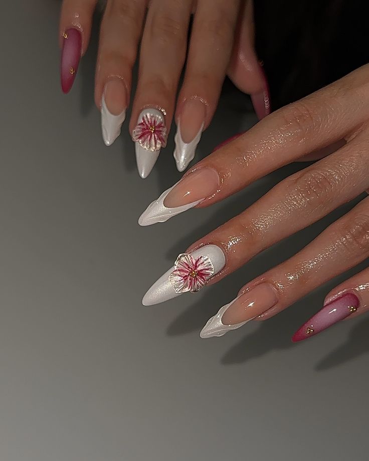 Elegant Floral Acrylic Nails with Pink and White Tones, Dramatic Shapes, and Gold Accents.