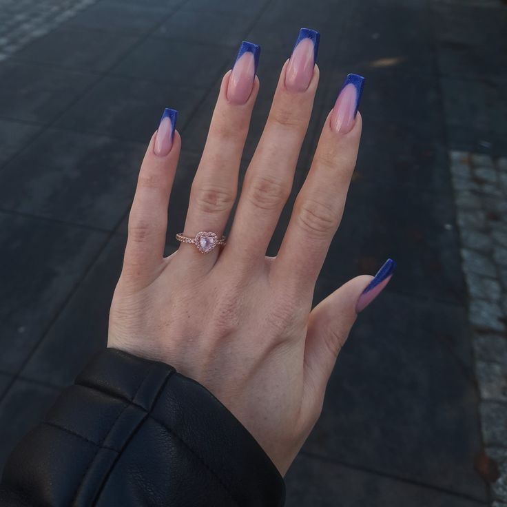 Chic Acrylic Nails: Elegant Pink and Blue Tips with Glossy Finish and Dainty Ring.