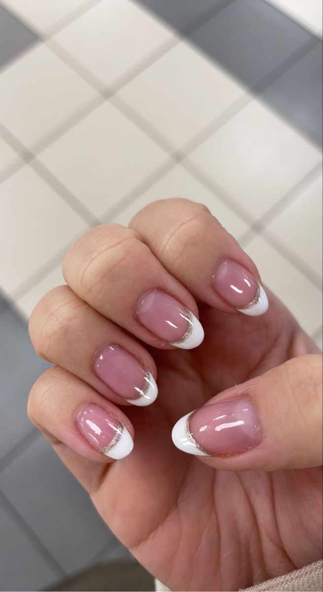 Sophisticated French Manicure with Elegant Gold Accents.