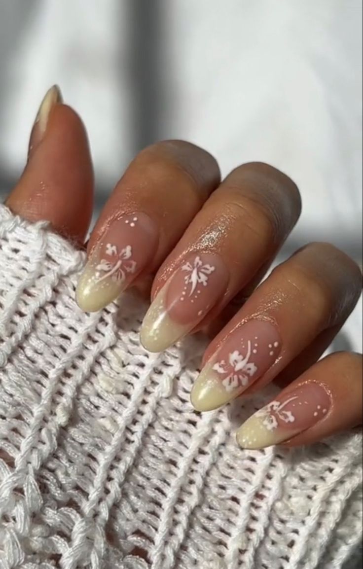 Sleek Nude and White Nail Art with Gradient and Floral Elegance.