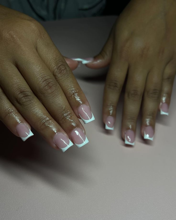 Sophisticated Elegant French Tip Nails: Polished Soft Pink Base with Crisp White Tips.