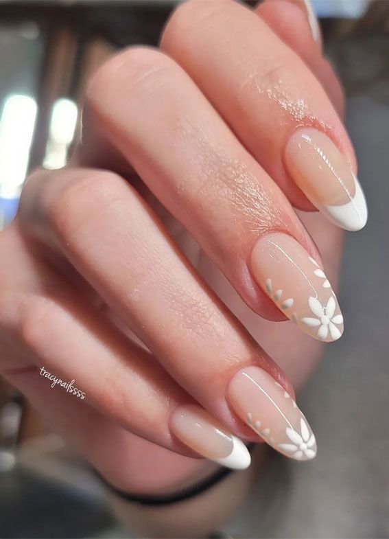 Sophisticated Nude French Manicure with Delicate Floral Tip Designs.