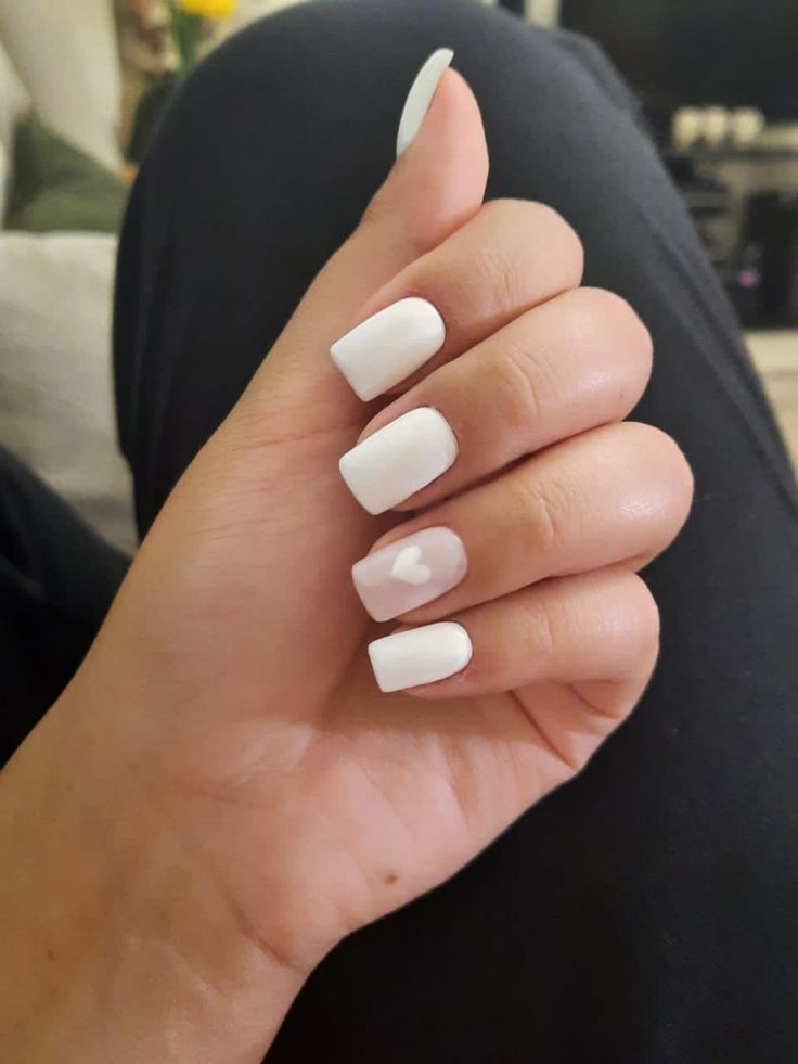 Chic White Nails with Glossy Finish and Charming Heart Design for Any Occasion.