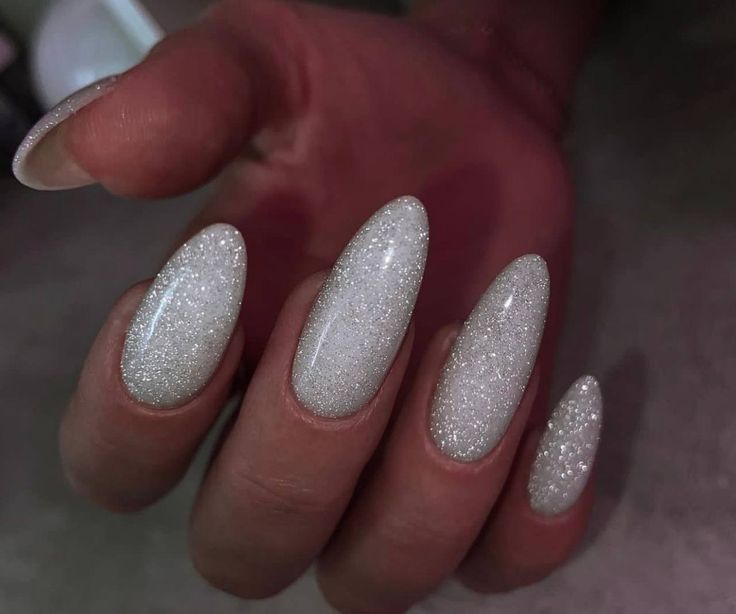 Elegant Almond-Shaped White Glitter Nails: Perfect for Any Occasion.