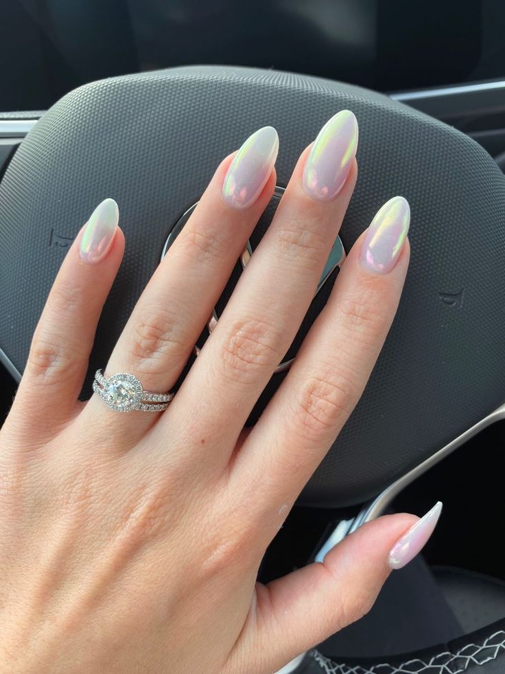 Chic Iridescent Almond-Shaped Nails: A Sophisticated Pink-to-White Gradient with Sparkling Accents.