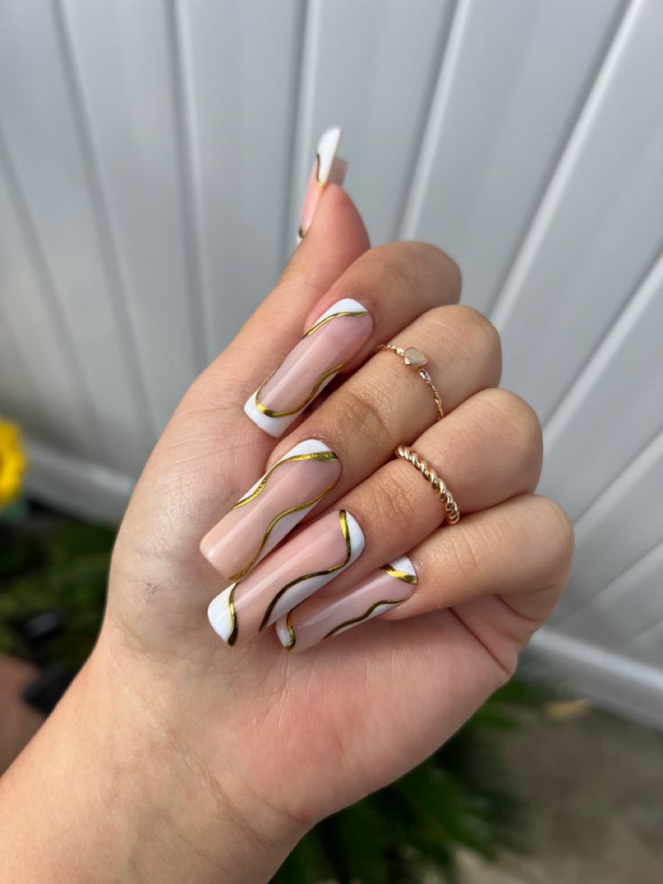 Chic Nude Nail Design with Glossy White Tips and Elegant Gold Accents