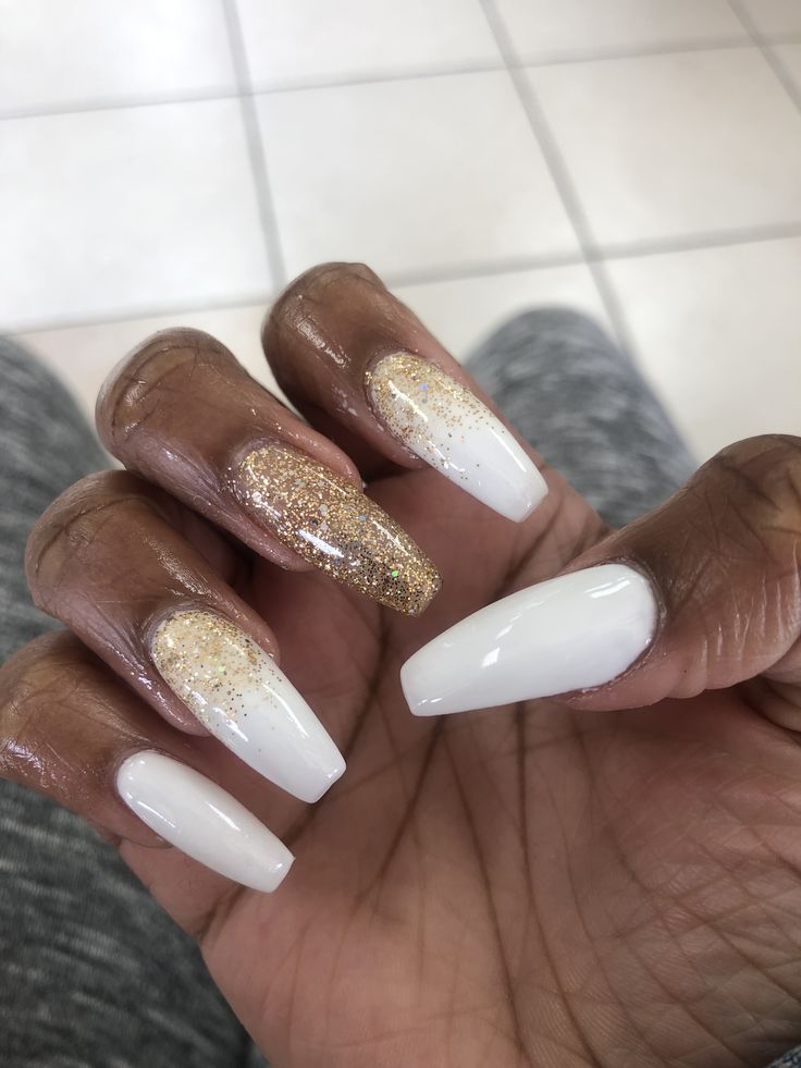 Elegant Almond-Shaped Nails with Chic White and Gold Accents.