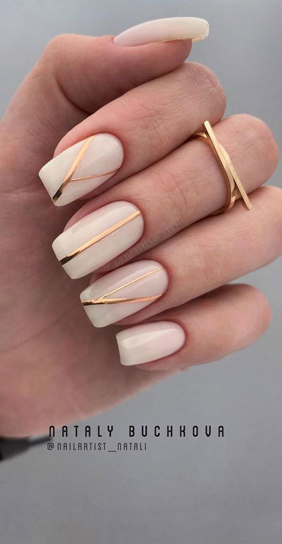 Elegant Nude and Metallic Gold Striped Nail Design: A Chic Contrast of Simplicity and Glamour