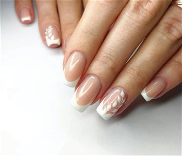 Chic Nail Design: Natural Nude Base with Classic White Tips and Artistic Leaf Patterns.