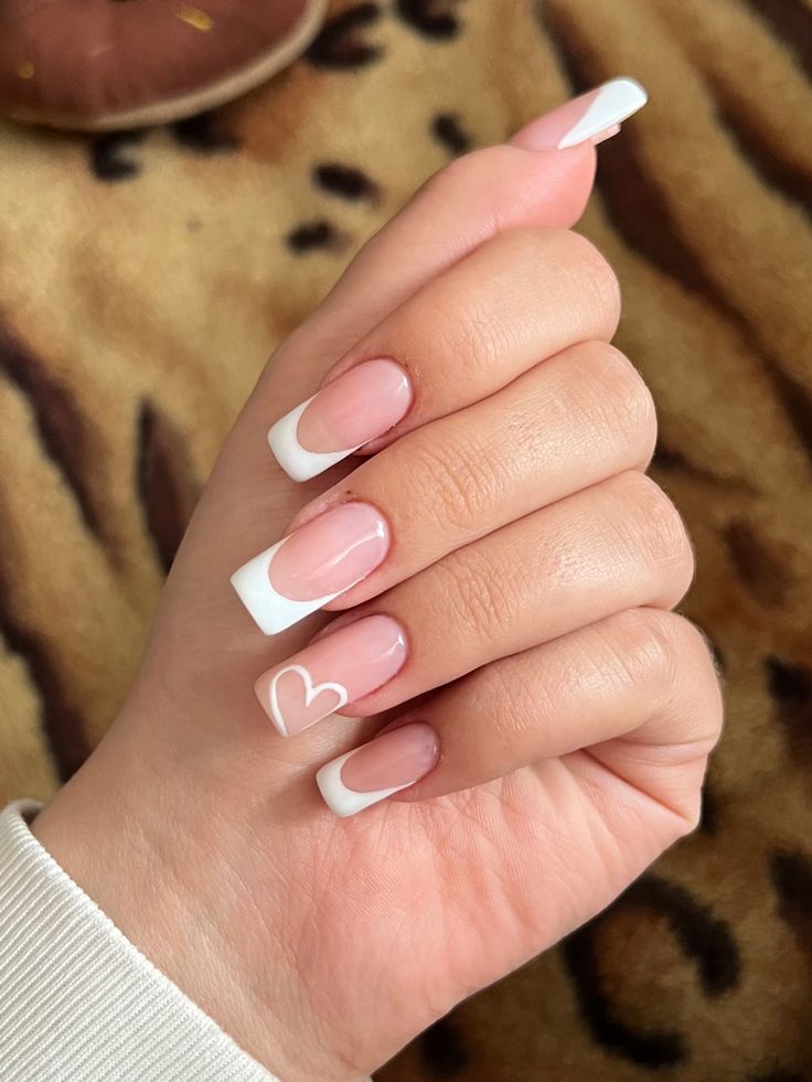 Charming Heart-Appliqued French Manicure: Elegant Light Pink and Classic White Tips.