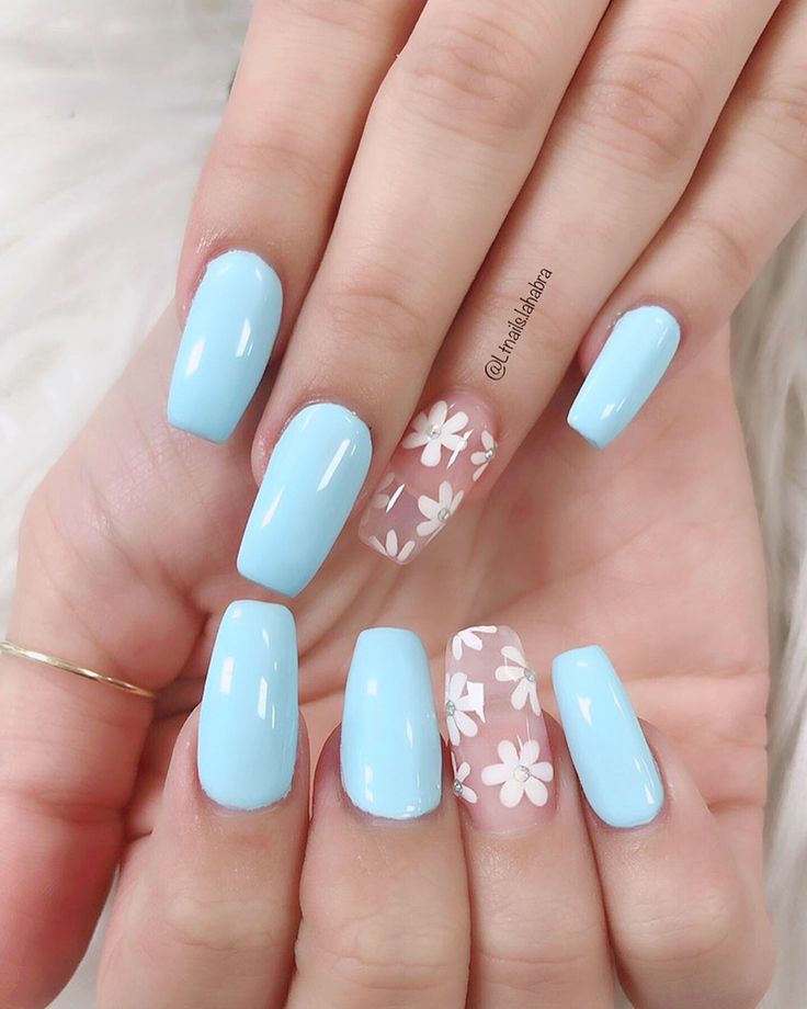 Elegant Soft Blue Nail Design with Whimsical Floral Accent for Spring/Summer.