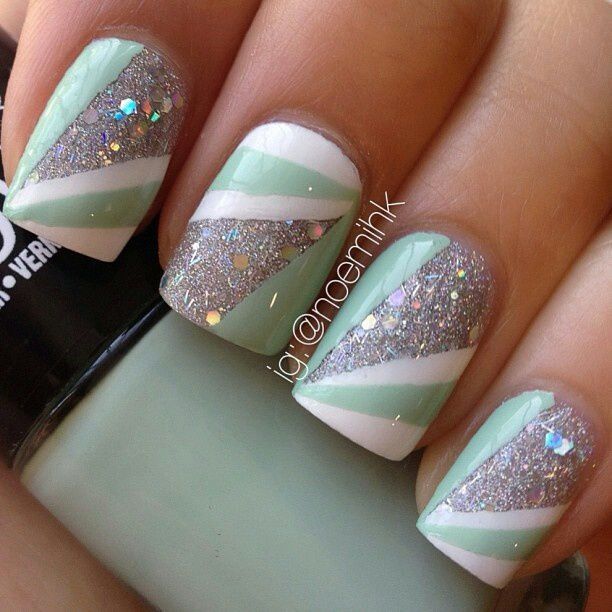 Trendy Pastel Green and Silver Geometric Nail Design with Glossy and Glittery Finishes.