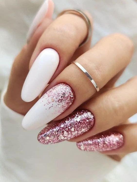 Elegant Chic Nail Design: Matte White Meets Sparkling Pink with Glittery Accents.