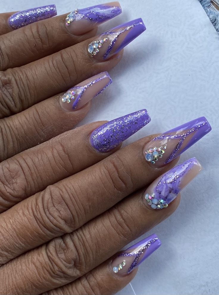 Elegant Vibrant Lavender Nail Design with Glossy, Glitter Finishes, and Rhinestone Accents.