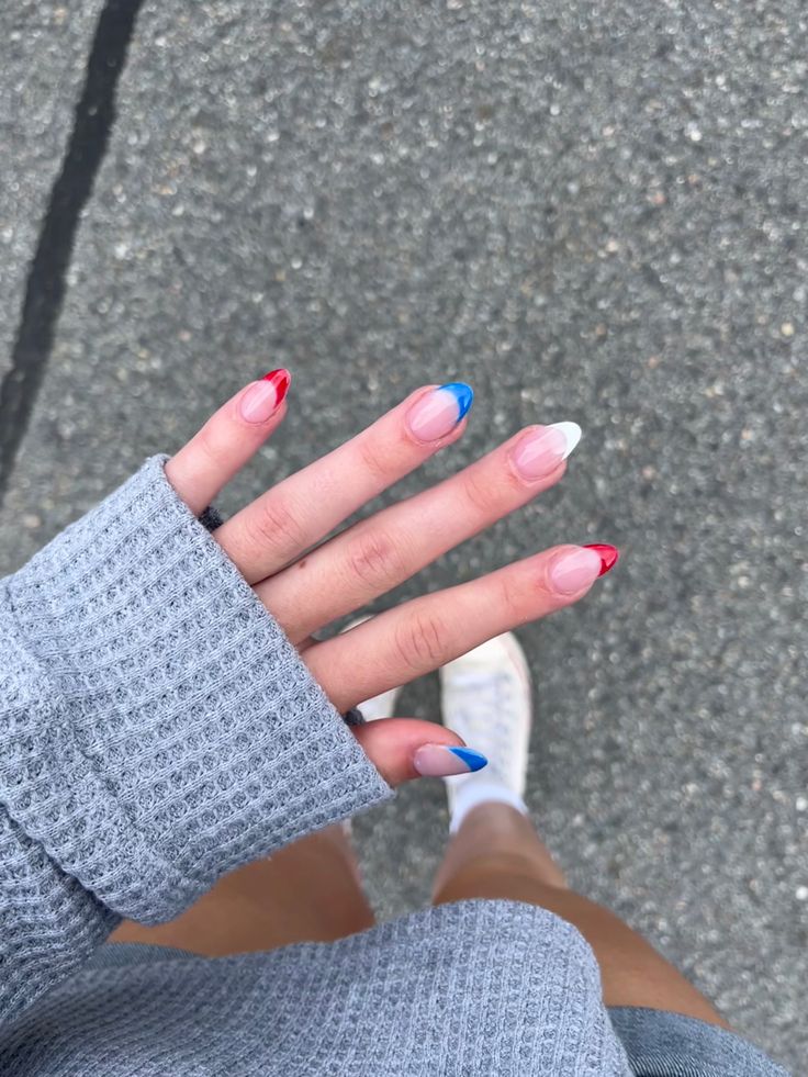 Vibrant Patriotic Nail Design: Playful Red, White, and Blue Almond-Shaped Elegance for Summer Celebrations.