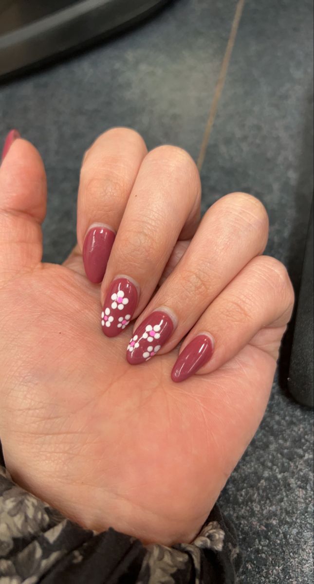 Elegant Burgundy Nail Design with Whimsical Floral Accents