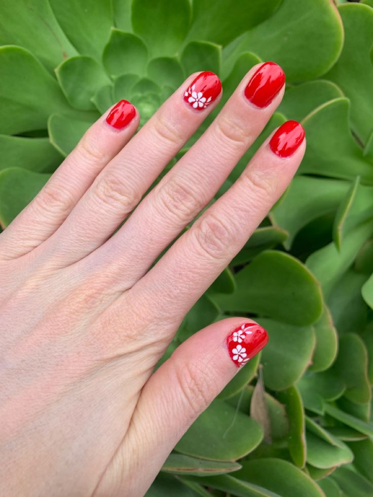 Striking Contrast: Vibrant Red Nails with Elegant White Floral Designs