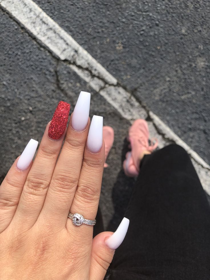 Chic Nail Design: Glossy White and Glittery Red with Elegant Accents.