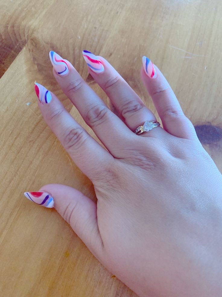 Vibrant Glossy Abstract Nail Design with Red, Blue, and Pink Swirls