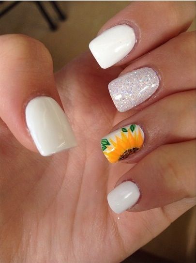 Vibrant Nail Design: Classic White Base with Glitter and Cheerful Sunflower Accent