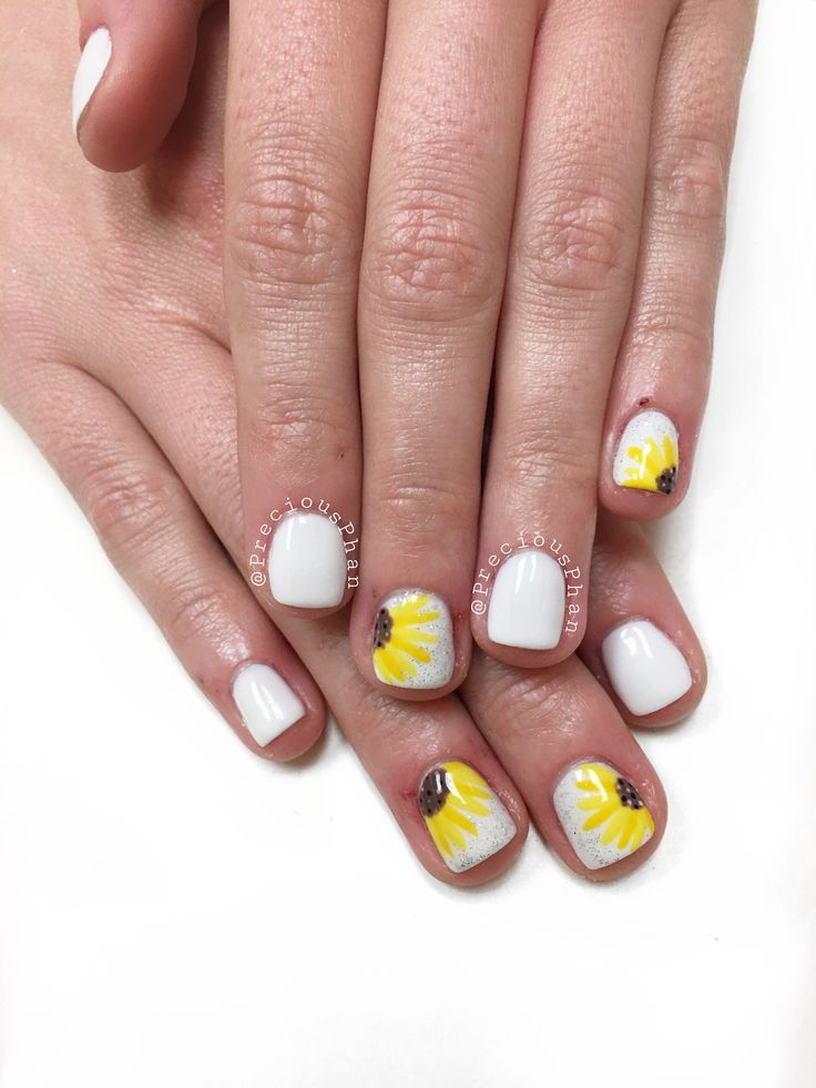 Charming Floral Nail Design: Vibrant Yellow Flowers on Solid White for a Fresh Spring Look.