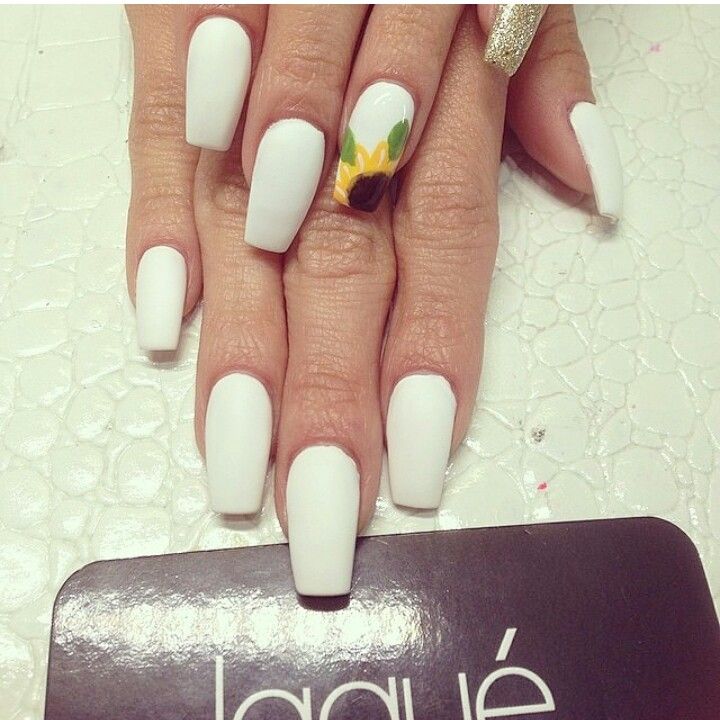 Chic White Nails with Sunflower Accent and Glitter Detail.