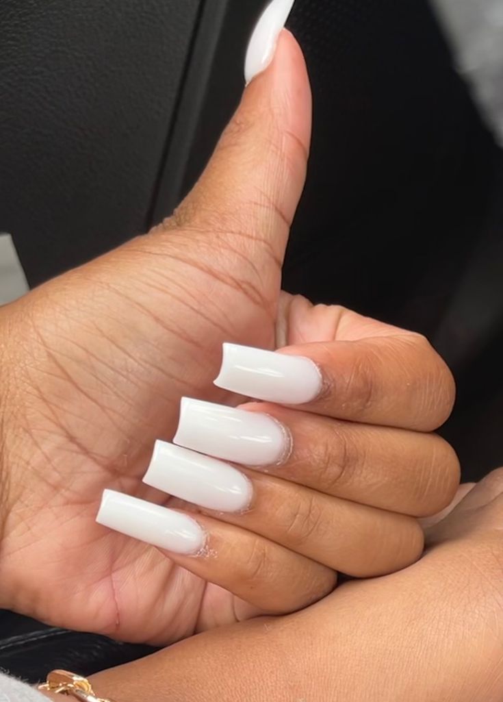 Elegant White Acrylic Nails: Glossy Finish and Long Square Shape for a Bold Statement.