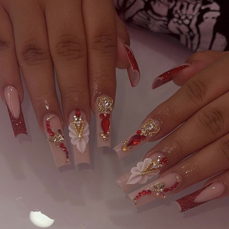 Elegant Nude Nail Design with Intricate Embellishments and Glamorous Accents.