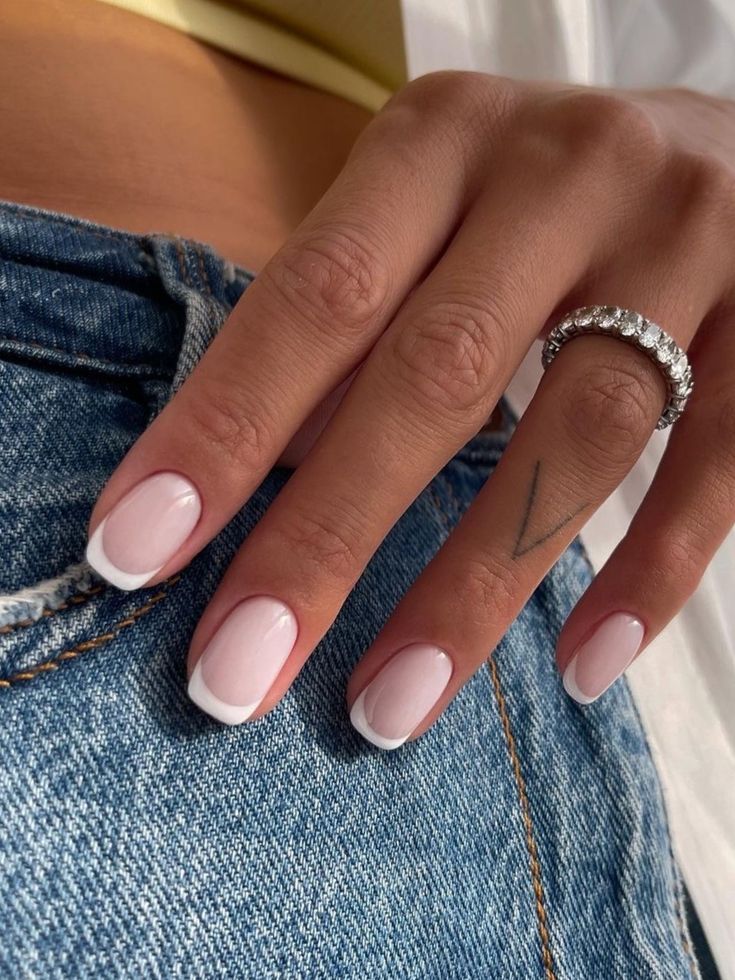 Chic and Sophisticated Soft Pink French Manicure with Delicate Accessories.