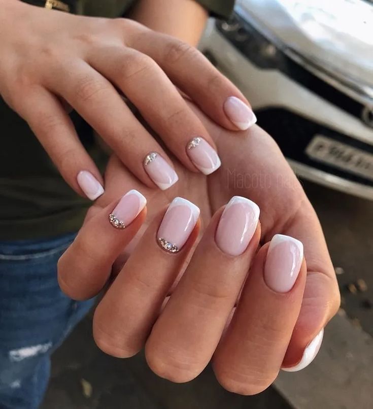 Chic Soft Pink and White Nail Design with Sparkling Rhinestone Accents