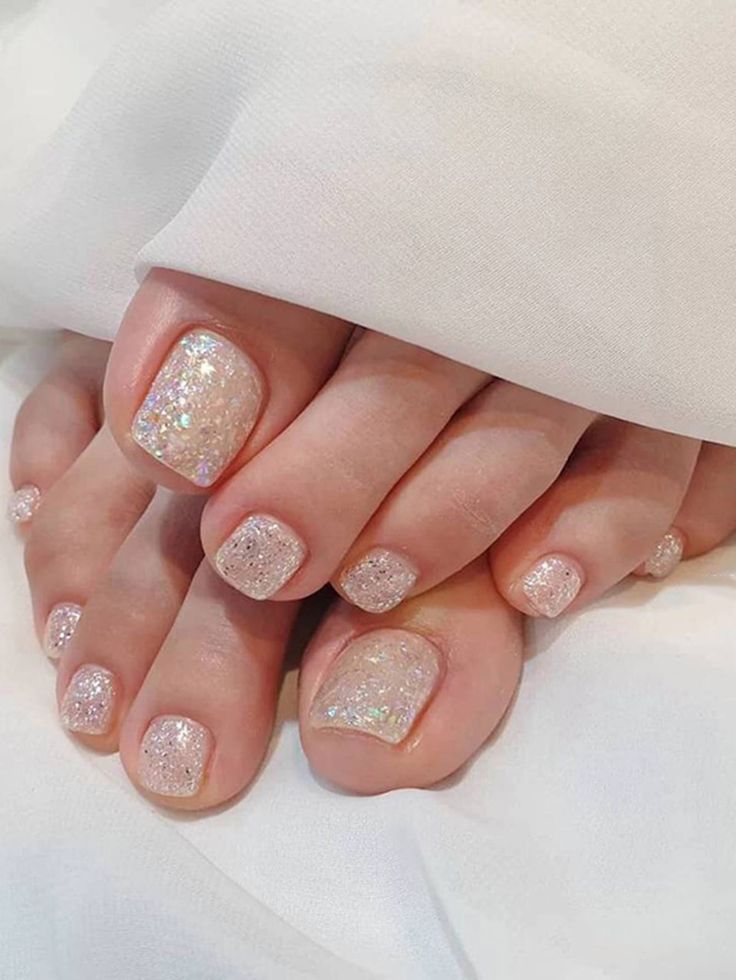 Delicate Pink Nail Design with Iridescent Glitter for Elegant Occasions.