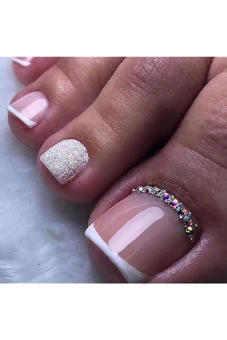 Sophisticated Nail Design: White Tips with Glitter Accent and Rhinestones