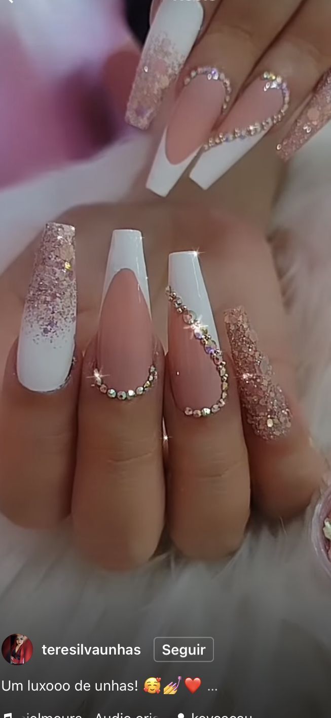 Glamorous Nude and White Nail Design with Intricate Embellishments and Rhinestones.