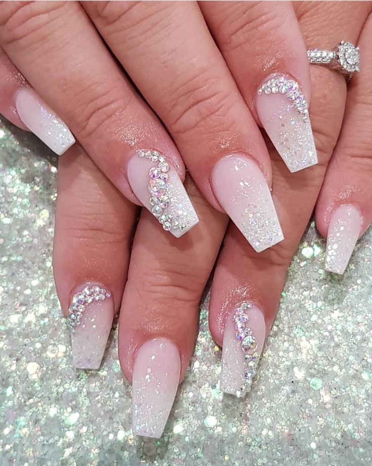 Chic White and Silver Glitter Nail Design with Rhinestone Embellishments.