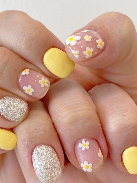 Springtime-Inspired Nail Design with Playful Colors, Patterns, and Glamorous Silver Accents.