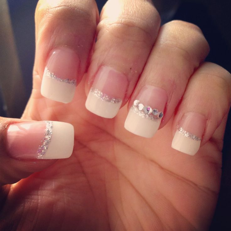 Elegant French Manicure with Soft Pink, Classic White Tips, and Rhinestone Accents for Special Occasions.