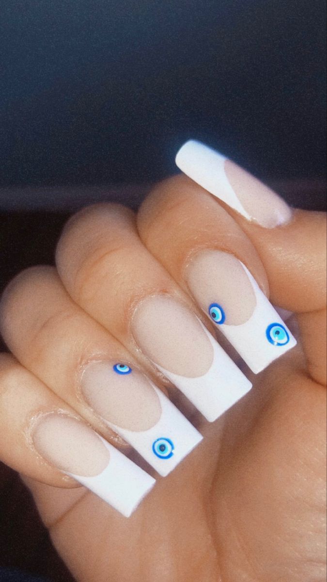 Chic Modern French Tip Nail Design with Unique Blue Eye Accents