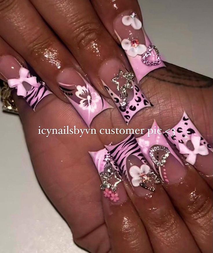 Chic Vibrant Nail Design: Playful Pink and Animal Print with Elegant 3D Embellishments.