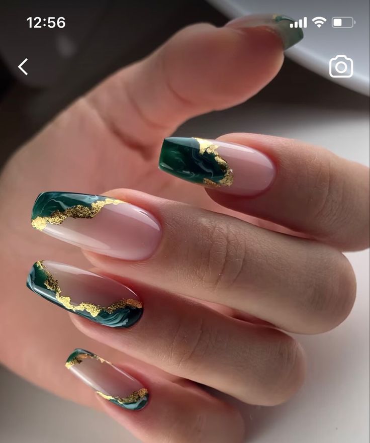 Sophisticated Nail Design: Deep Green and Nude with Metallic Gold Accents.