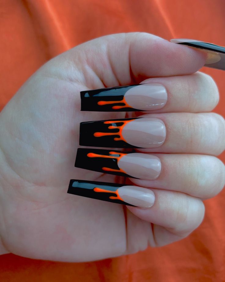 Bold Long Square Nail Design with Glossy Black, Nude Base, and Playful Orange Drips.