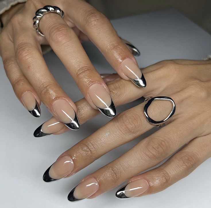 Elegant Black Tip Nails: A Sophisticated Contrast with Glossy Finish and Silver Accents.