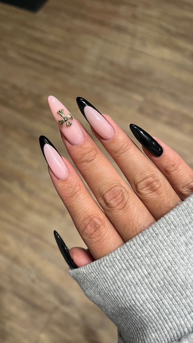 Chic Almond-Shaped Nail Design: Soft Pink and Glossy Black with Glamorous Accent.