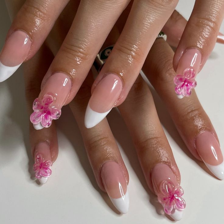 Chic French Tip Nail Design with Glossy Finish and Whimsical Pink Floral Accents