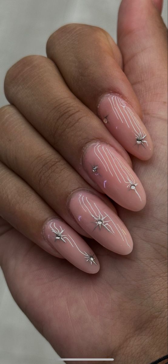 Chic Nude Nail Design with Silver Line Art and Shimmering Star Accents.