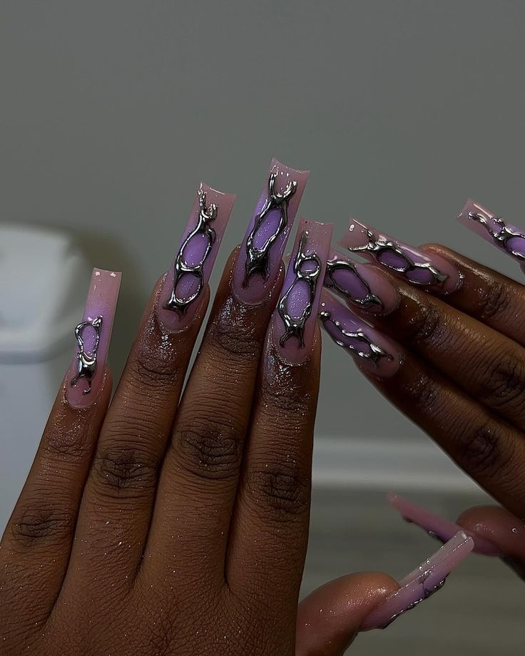 Elegant Long Nails with Muted Pink and Purple Tones Enhanced by Metallic Chains and Glossy Finish.